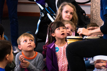 Group of children listening to a teacher at Storytime at the Bullock Museum