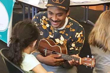 man and a child playing guitars in the Bullock Museum