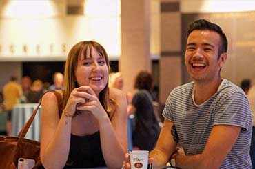 two adults drinking and smiling in the Bullock Museum