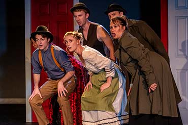 five people in costumes on a stage in the play Murders and Moontowers