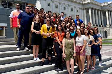 Group of students and teachers standing on the steps at Capitol Hill