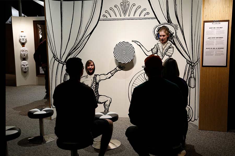 four adolescents standing around an interactive touch table in the Mind Matters exhibit