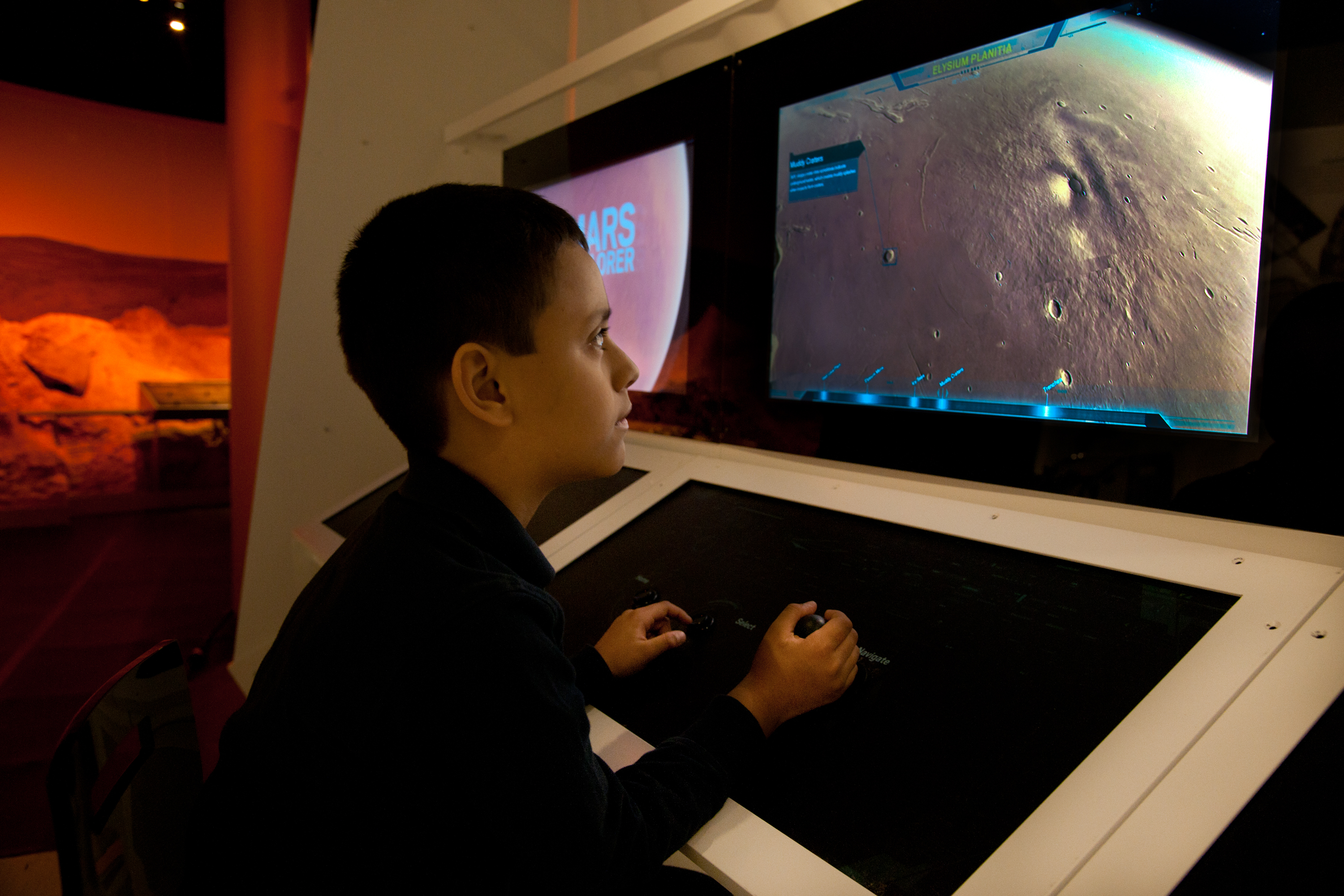 In Beyond Planet Earth, visitors can fly around Mars and zoom in on cavernous craters, massive volcanoes, and vast valleys with an interactive Mars Explorer console.