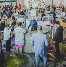 Large group of people drinking and talking in the Grand Lobby