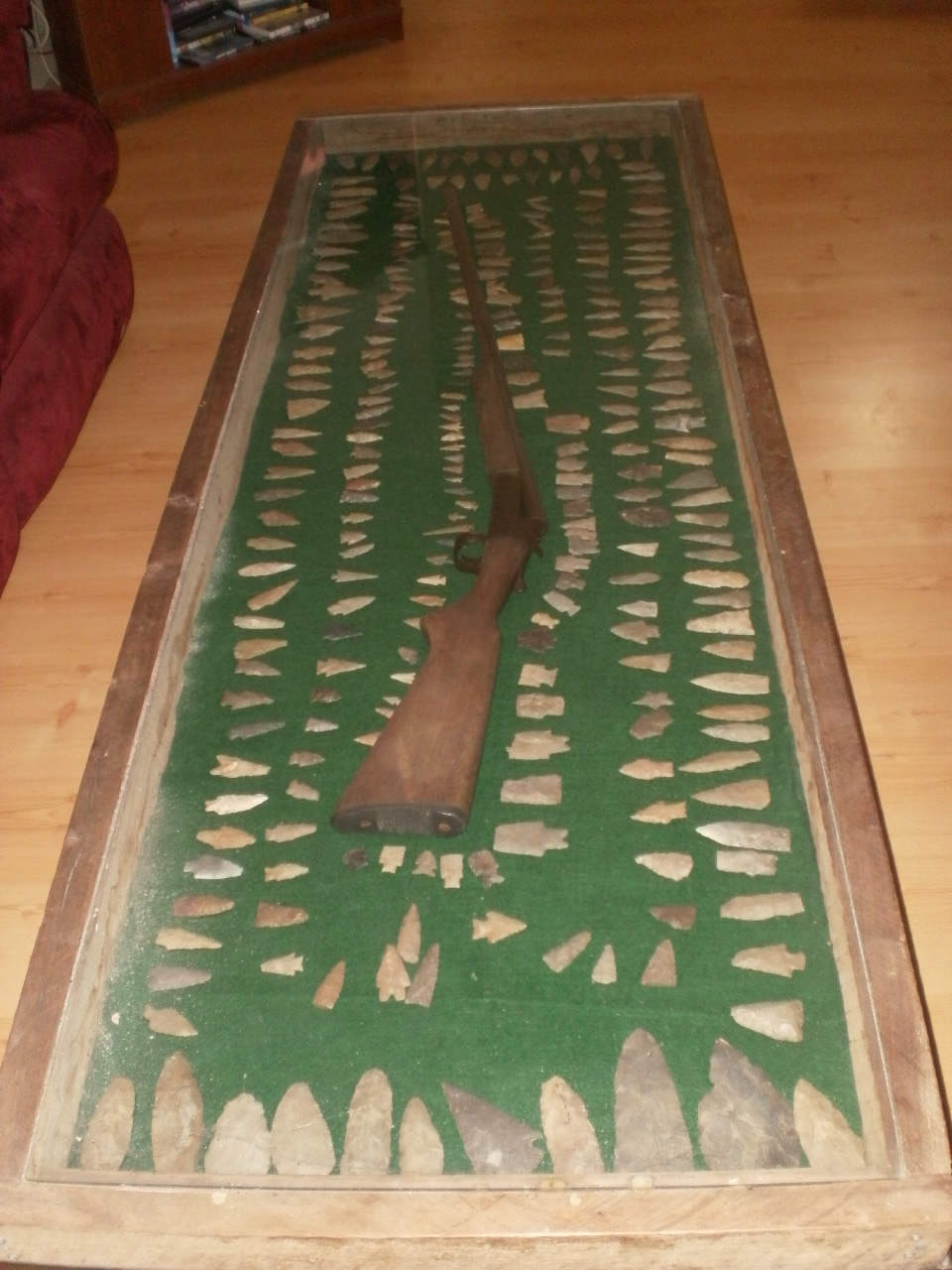 Coffee table with gun and arrowheads