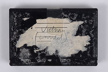 Black audio tape with a label that reads, "Vietnam (wounded)"