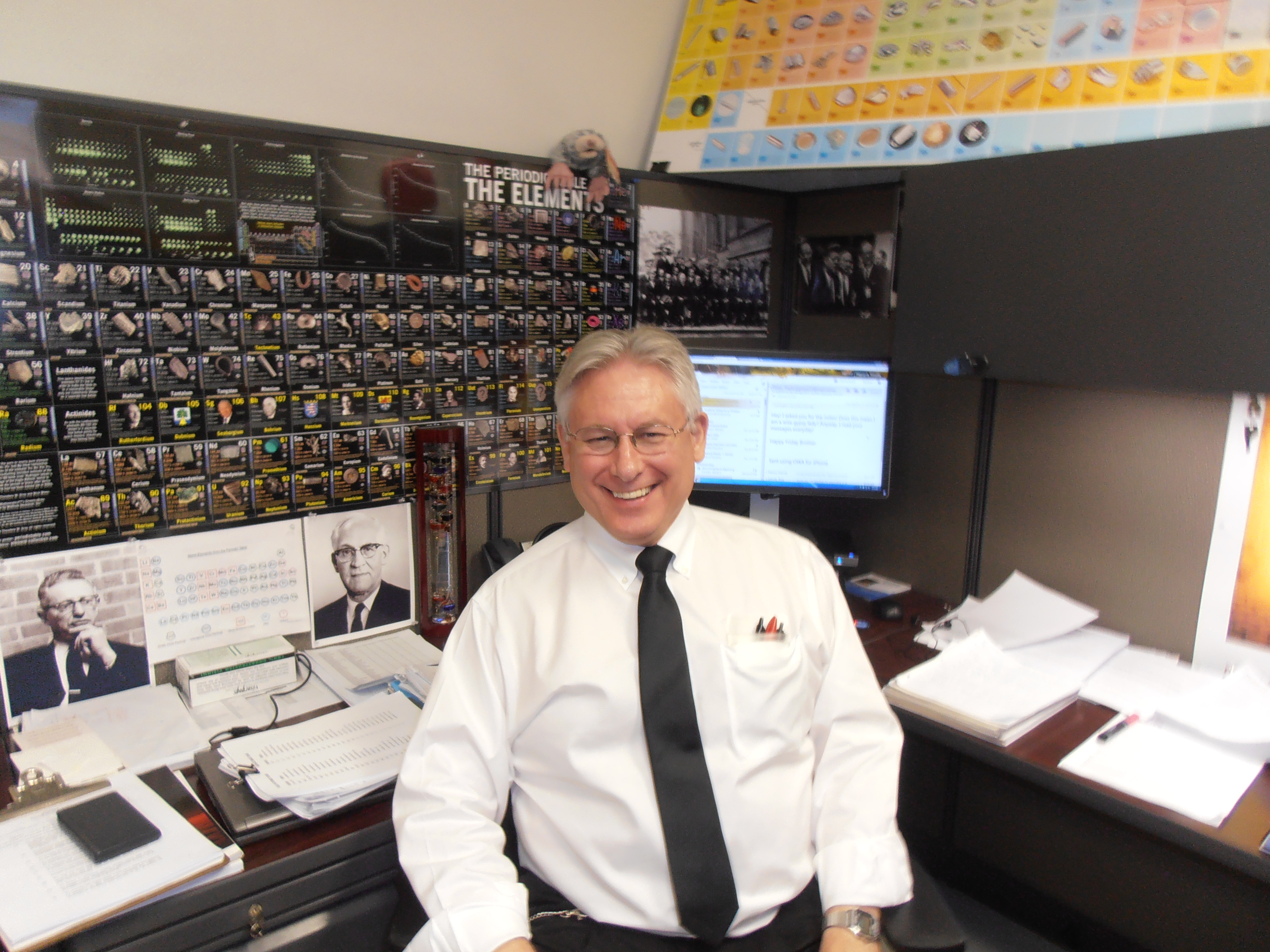 Brother Tim Pieprzyca smiles joyfully as he sits in his office. 