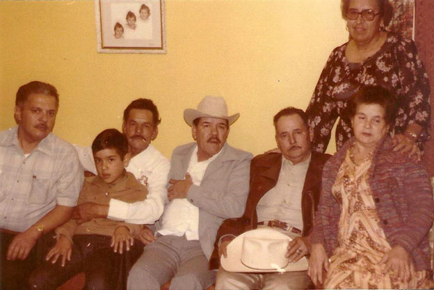 Photograph from left to right: Enrique Ruiz Montalvo, Lorenzo Ruiz Montalvo, Pablo Ruiz Montalvo (wearing hat, Noe’s father), Octavio Ruiz Montalvo, lady sitting down Alfa Dalia Ruiz Montalvo (aunt) and lady standing in back is Hermina Ruiz, aunt, and of course, Noe, sitting next to his father on Lorenzo Ruiz Montalvo’s lap.